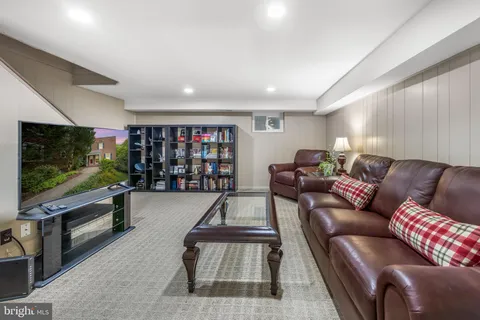 a view of a workspace with furniture and a bookshelf