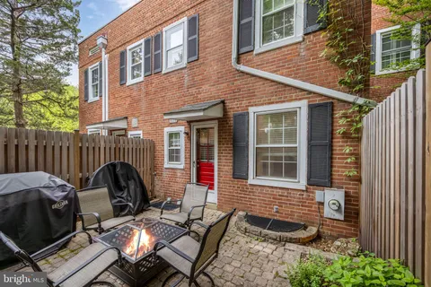 a view of a chairs and tables in the back yard of the house