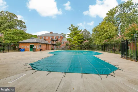 a view of a swimming pool with a yard