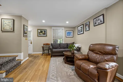 a living room with furniture window and a flat screen tv