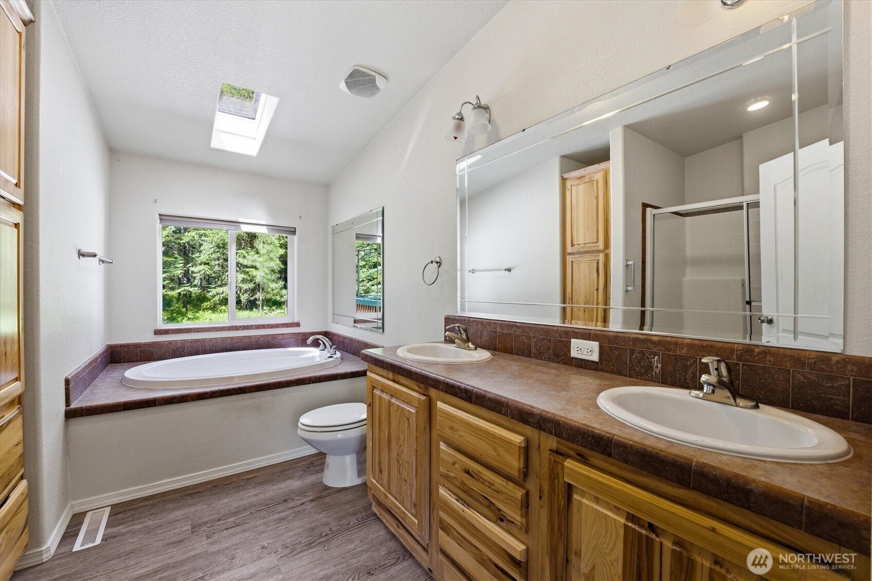 1142 Driskill Road Newport, WA 99156 - Photo 16 of 40 a bathroom with a granite countertop sink mirror toilet and bathtub
