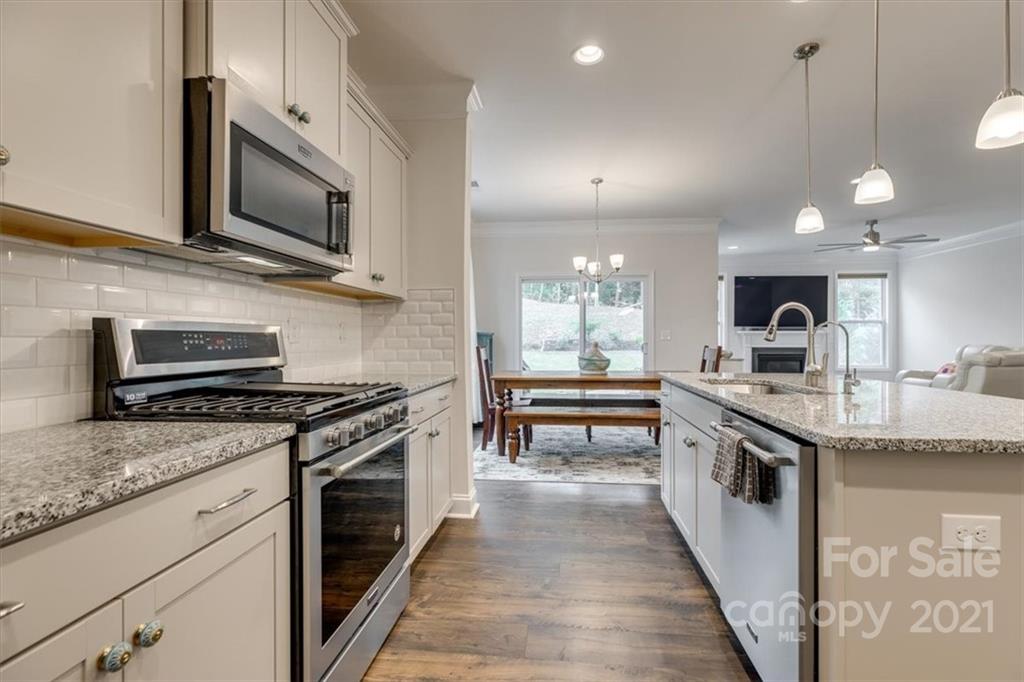 1007 Lydney Circle Waxhaw, NC 28173 - Photo 13 of 46 a kitchen with stainless steel appliances granite countertop a stove a sink and a microwave