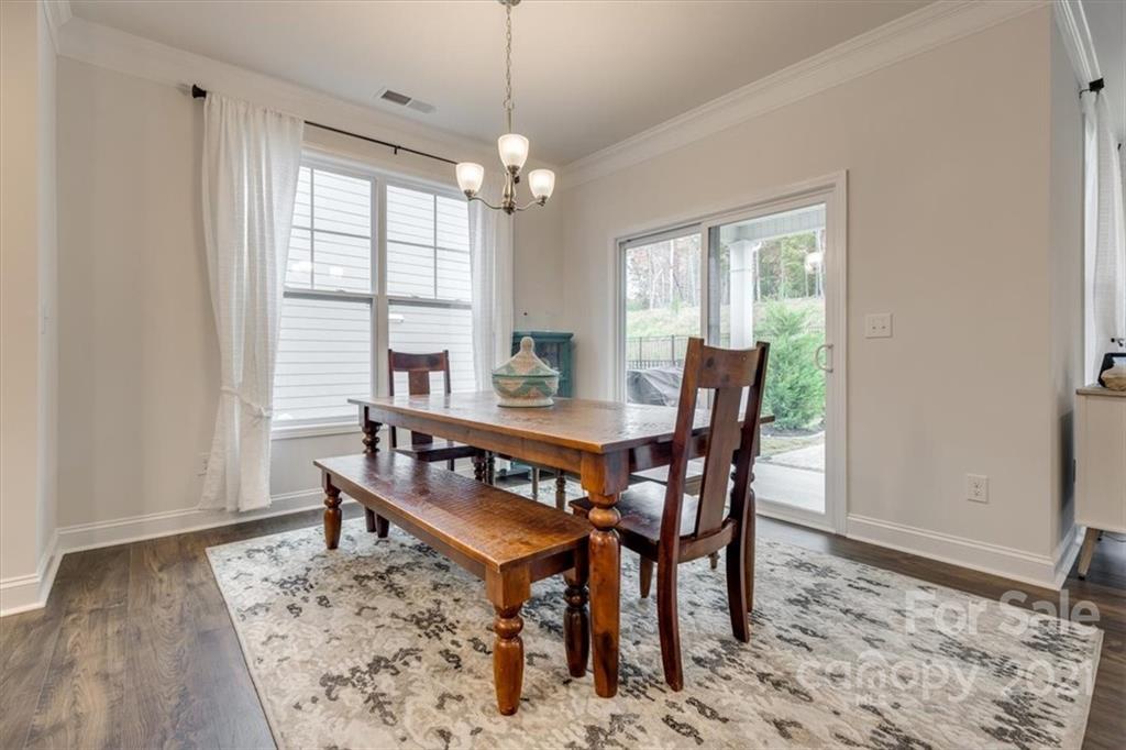 1007 Lydney Circle Waxhaw, NC 28173 - Photo 16 of 46 a view of a dining room with furniture window and wooden floor