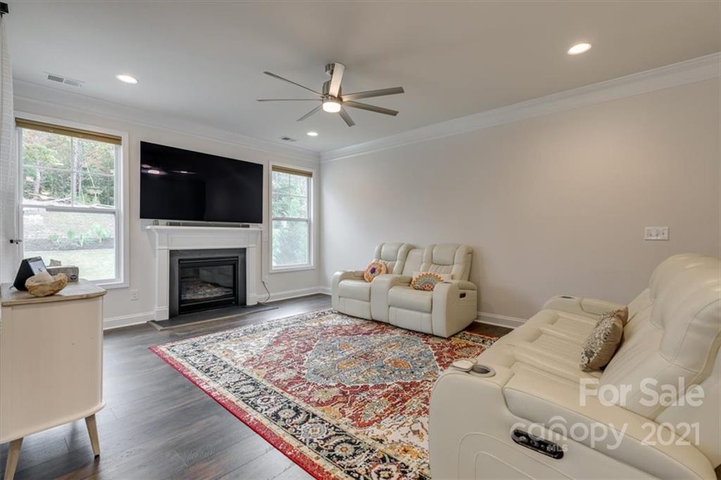 1007 Lydney Circle Waxhaw, NC 28173 - Photo 17 of 46 a living room with furniture a flat screen tv and a fireplace