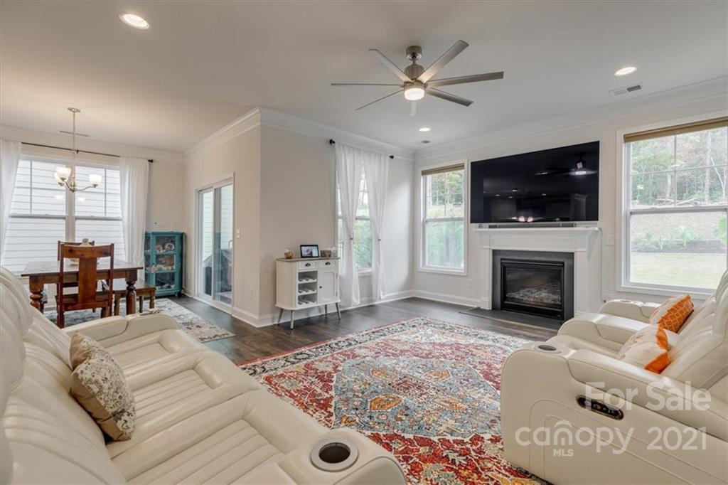 1007 Lydney Circle Waxhaw, NC 28173 - Photo 18 of 46 a living room with furniture a flat screen tv and a fireplace