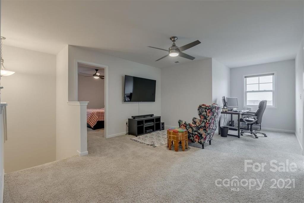 1007 Lydney Circle Waxhaw, NC 28173 - Photo 30 of 46 a living room with furniture and a flat screen tv
