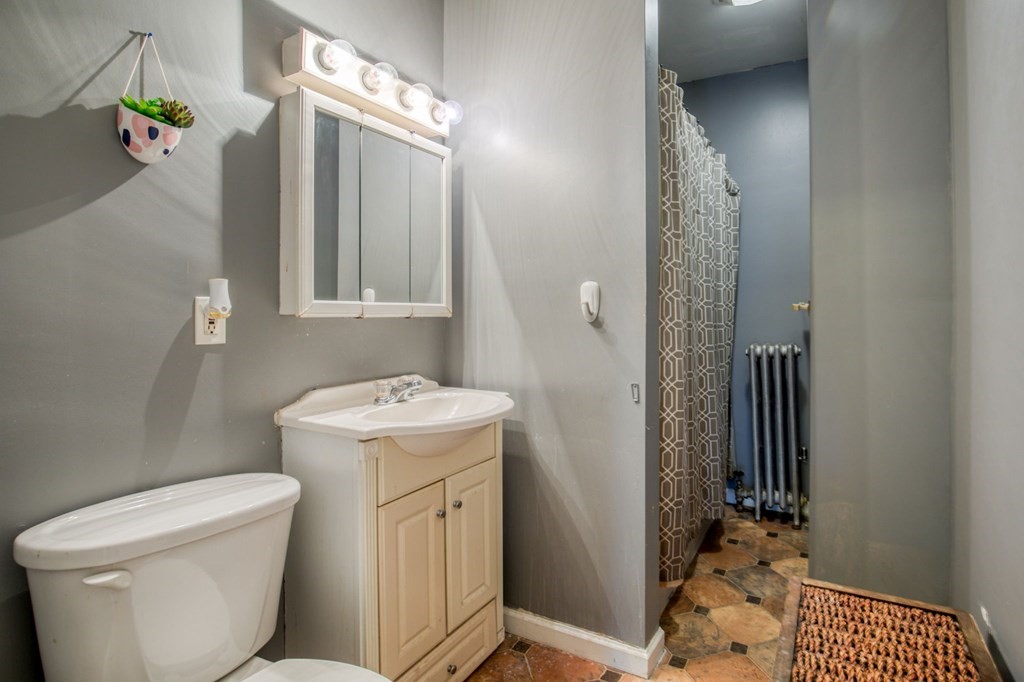 2129 Northampton Street Holyoke, MA 01040 - Photo 12 of 25 a bathroom with a sink a toilet and shower