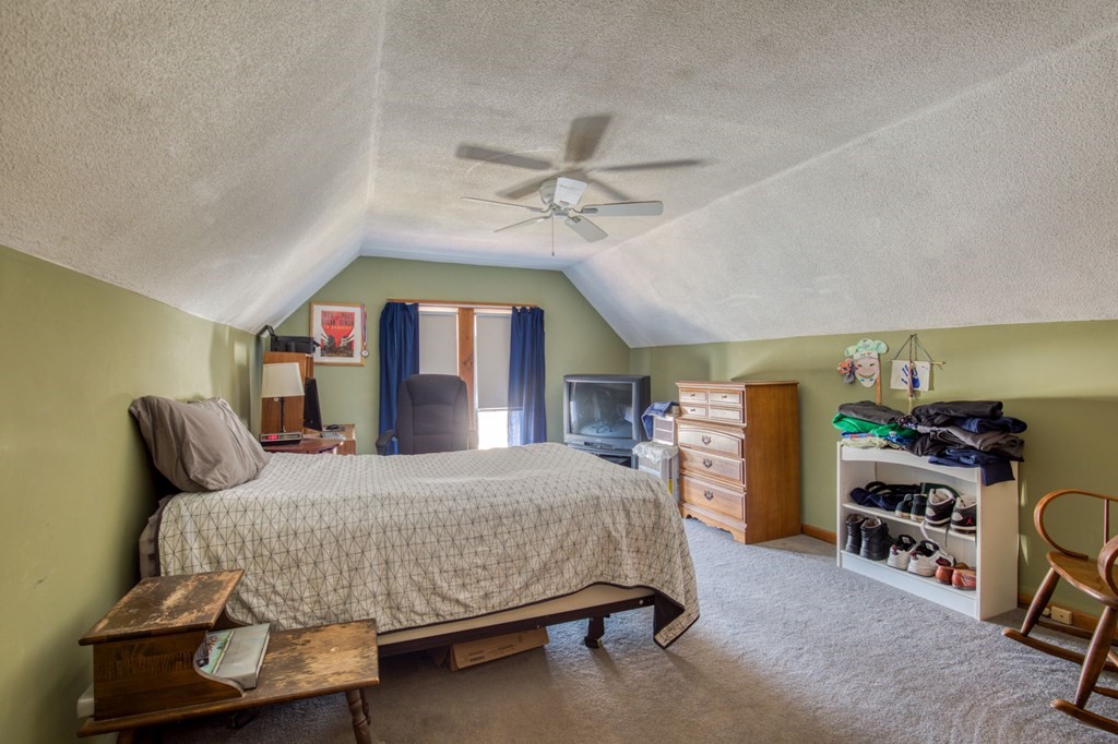 2129 Northampton Street Holyoke, MA 01040 - Photo 13 of 25 a bedroom with a bed a chandelier and dresser