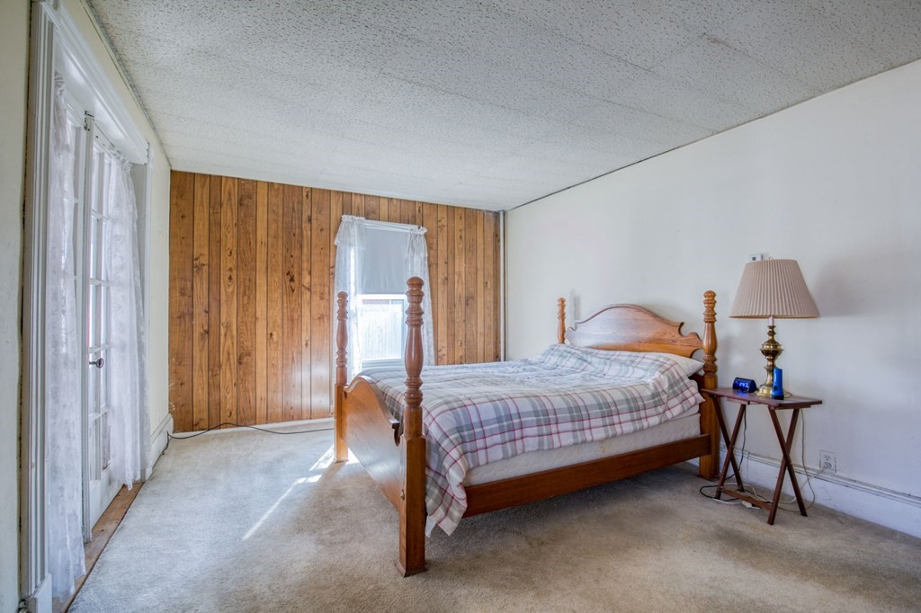 2129 Northampton Street Holyoke, MA 01040 - Photo 17 of 25 a bedroom with a bed and a table in it