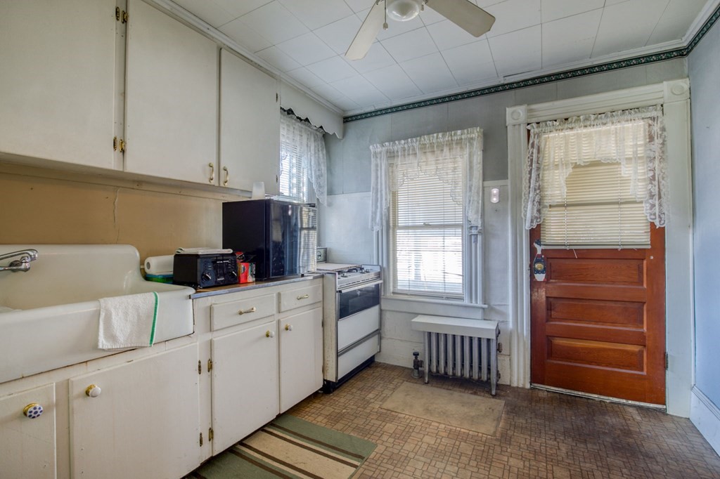 2129 Northampton Street Holyoke, MA 01040 - Photo 18 of 25 a kitchen with a refrigerator and white cabinets