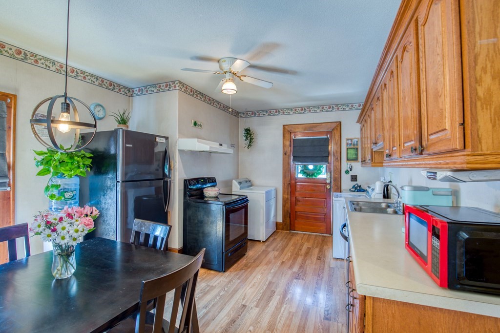 2129 Northampton Street Holyoke, MA 01040 - Photo 3 of 25 a kitchen with stainless steel appliances granite countertop a refrigerator dining table and chairs