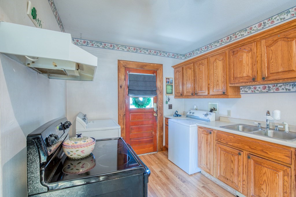 2129 Northampton Street Holyoke, MA 01040 - Photo 5 of 25 a kitchen with stainless steel appliances wooden cabinets and a stove top oven
