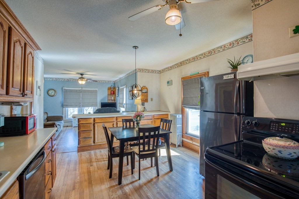 2129 Northampton Street Holyoke, MA 01040 - Photo 7 of 25 a kitchen with stainless steel appliances kitchen island granite countertop a table chairs stove and cabinets
