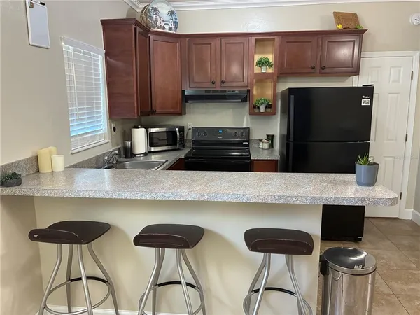 a kitchen with stainless steel appliances a stove a sink refrigerator and cabinets