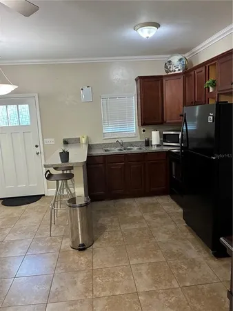 a large kitchen with kitchen island granite countertop a large counter top space appliances and cabinets