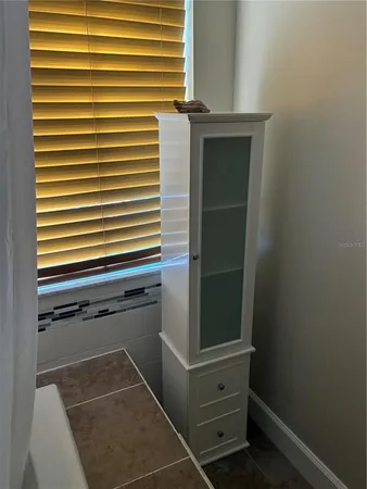 a balcony with wooden floor table and chairs
