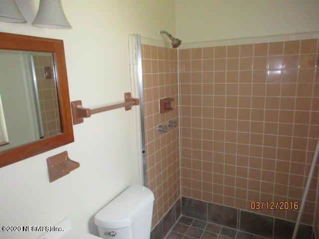 7655 Falcon Street Jacksonville, FL 32244 - Photo 11 of 13 a bathroom with a toilet a sink and mirror