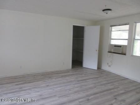 7655 Falcon Street Jacksonville, FL 32244 - Photo 3 of 13 a view of an empty room with wooden floor and a window