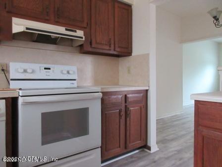 7655 Falcon Street Jacksonville, FL 32244 - Photo 4 of 13 a stove top oven sitting inside of a kitchen