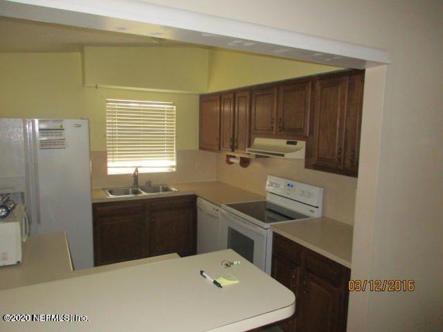 7655 Falcon Street Jacksonville, FL 32244 - Photo 5 of 13 a kitchen with a sink a stove and refrigerator