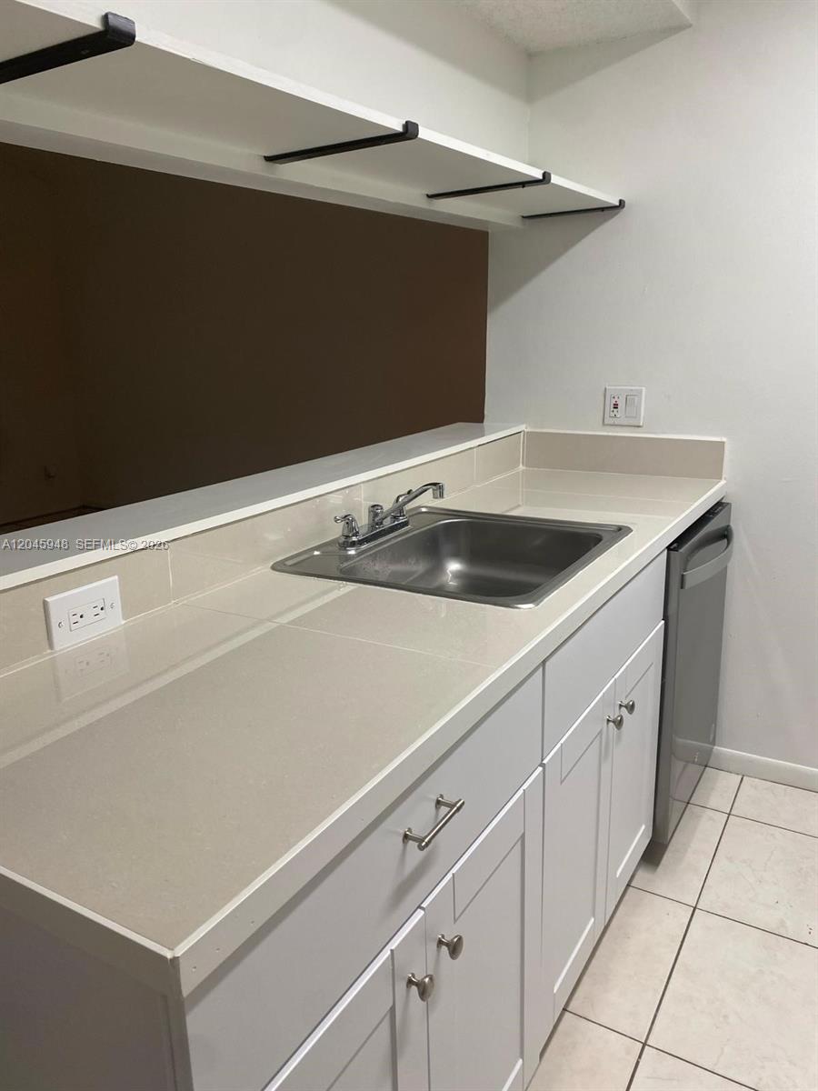 5612 Rock Island Road, Unit 167 Tamarac, FL 33319 - Photo 5 of 16 a view white cabinets and a sink