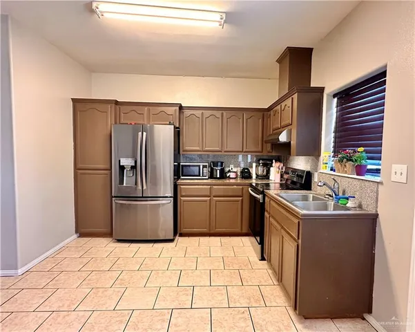 a kitchen with a refrigerator and a sink