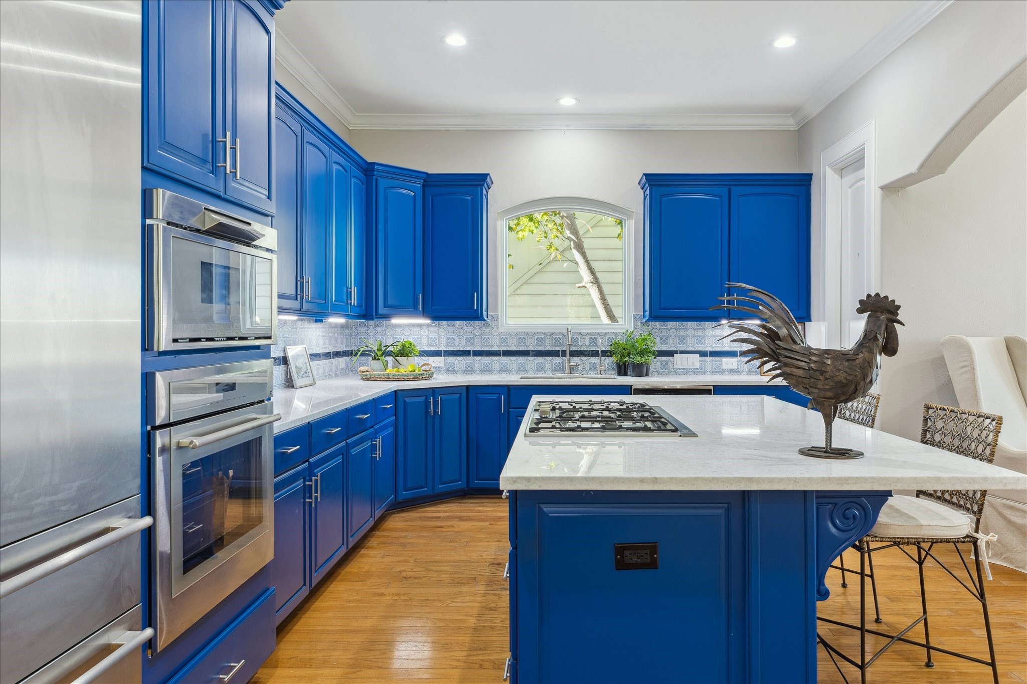 4701 Inker Street Houston, TX 77007 - Photo 18 of 45 a kitchen with kitchen island granite countertop a sink cabinets stainless steel appliances and a window