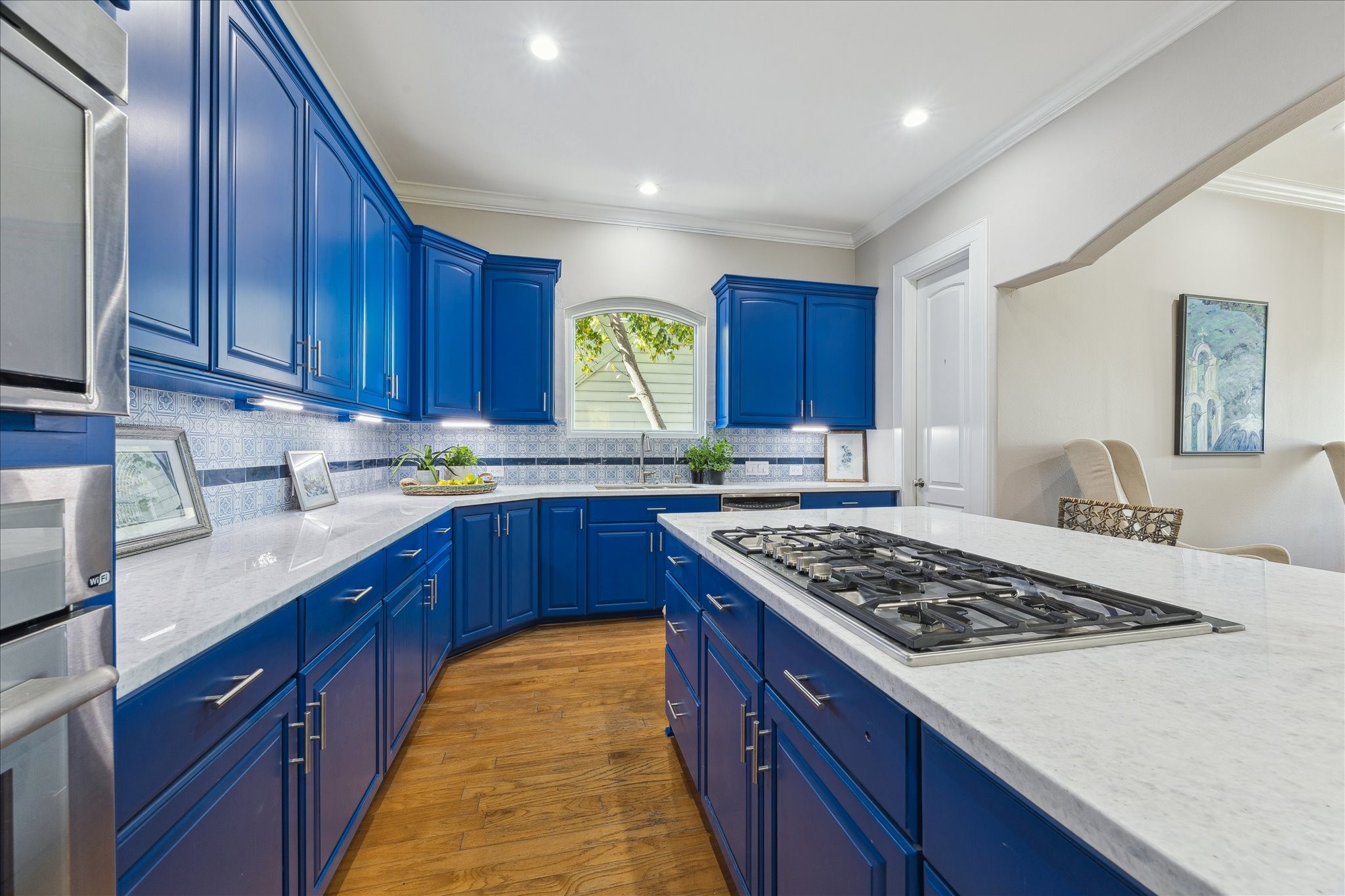 4701 Inker Street Houston, TX 77007 - Photo 19 of 45 a kitchen with stainless steel appliances granite countertop a stove a sink dishwasher and wooden cabinets with wooden floor