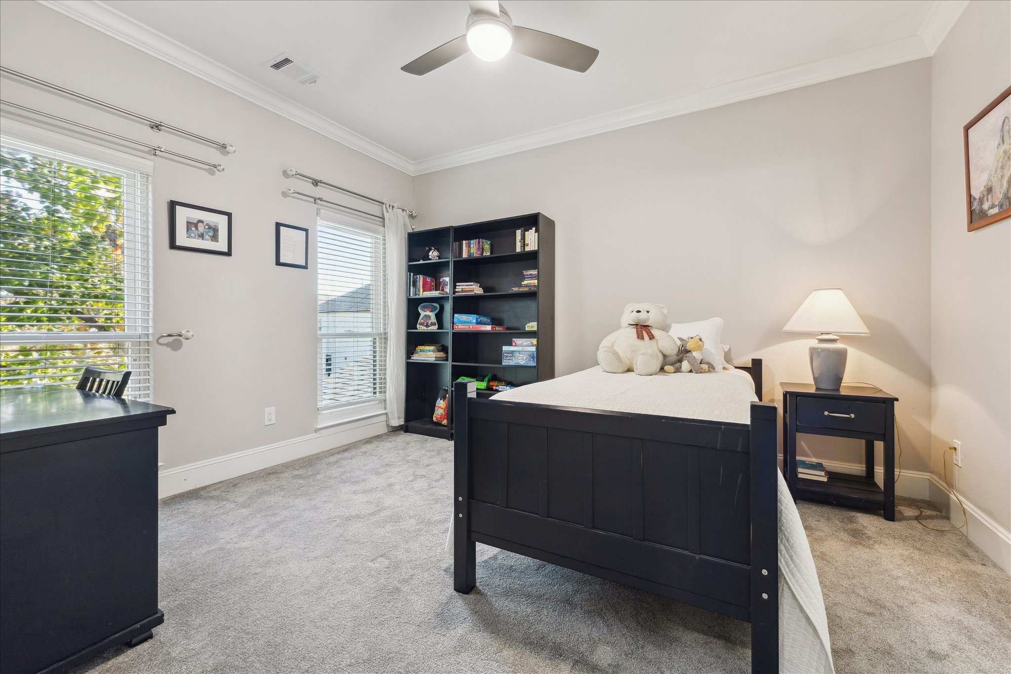 4701 Inker Street Houston, TX 77007 - Photo 34 of 45 a bedroom with a bed and a book shelf