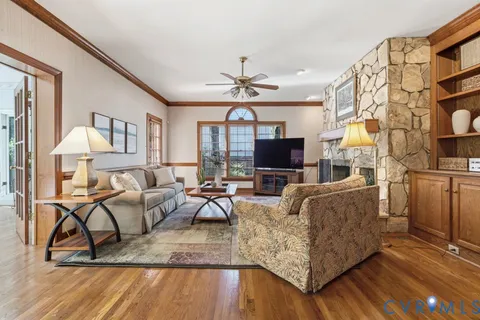 a living room with furniture kitchen view and a fireplace