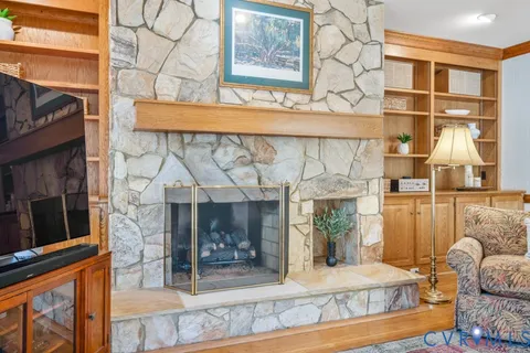 a living room with furniture and large windows