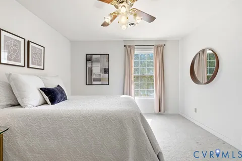 a bedroom with furniture and a window