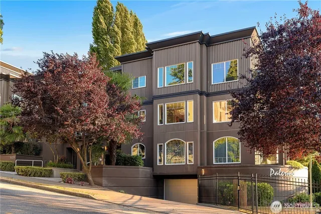 a front view of a house with a tree