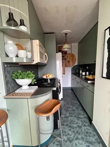 a kitchen with stainless steel appliances granite countertop a sink and a stove