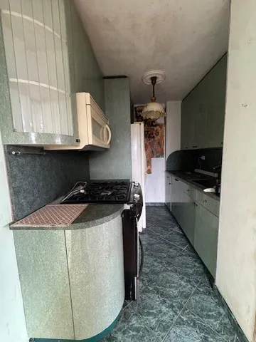 a kitchen with granite countertop a stove and a sink