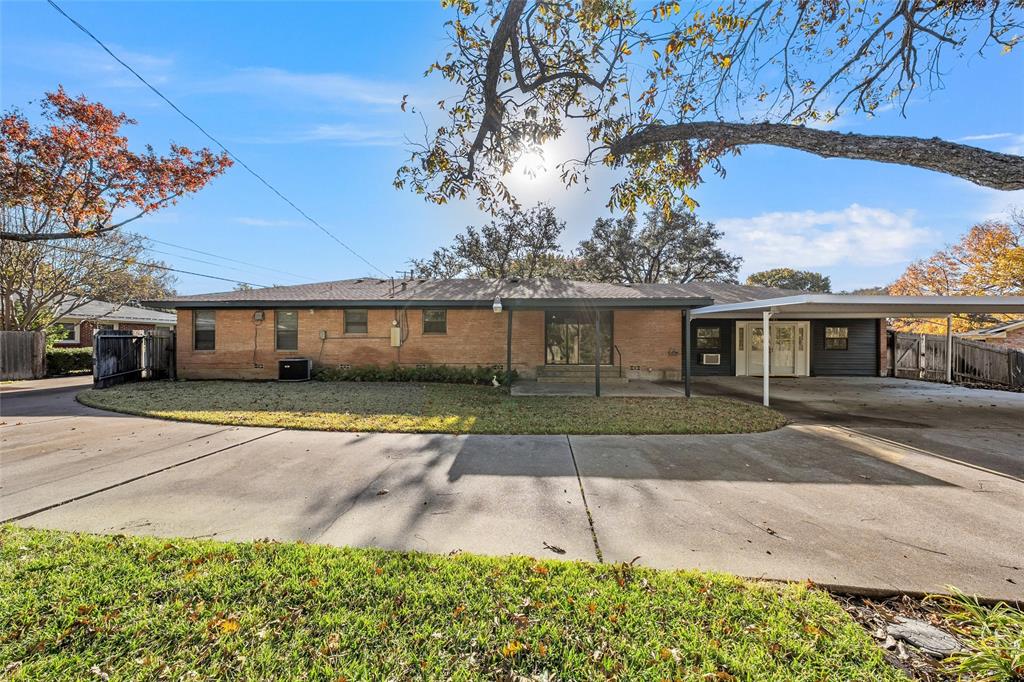 5201 Pine Avenue Waco, TX 76710 - Photo 27 of 33 a front view of a house with a garden and outdoor seating