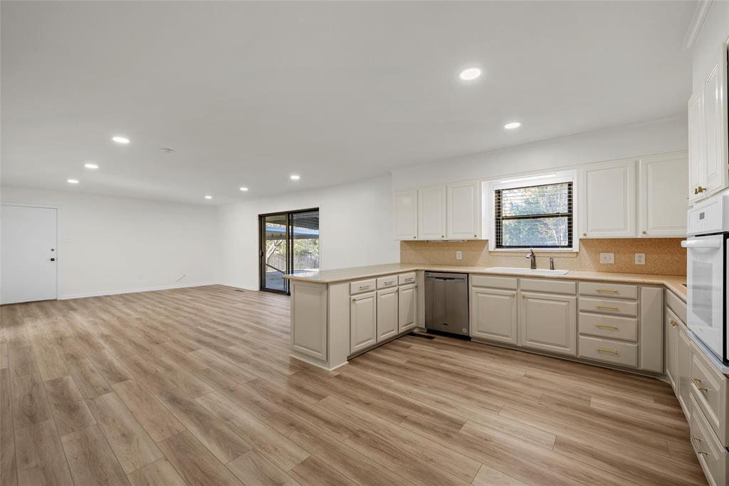 5201 Pine Avenue Waco, TX 76710 - Photo 8 of 33 a kitchen with a white cabinets counter top space and stainless steel appliances