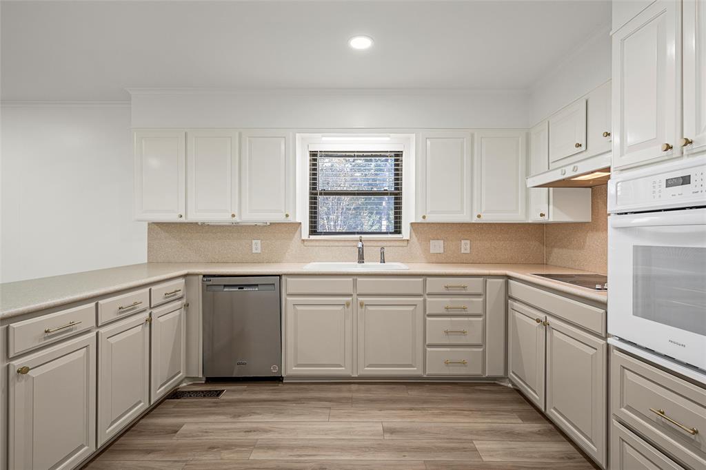 5201 Pine Avenue Waco, TX 76710 - Photo 9 of 33 a kitchen with white cabinets and white appliances