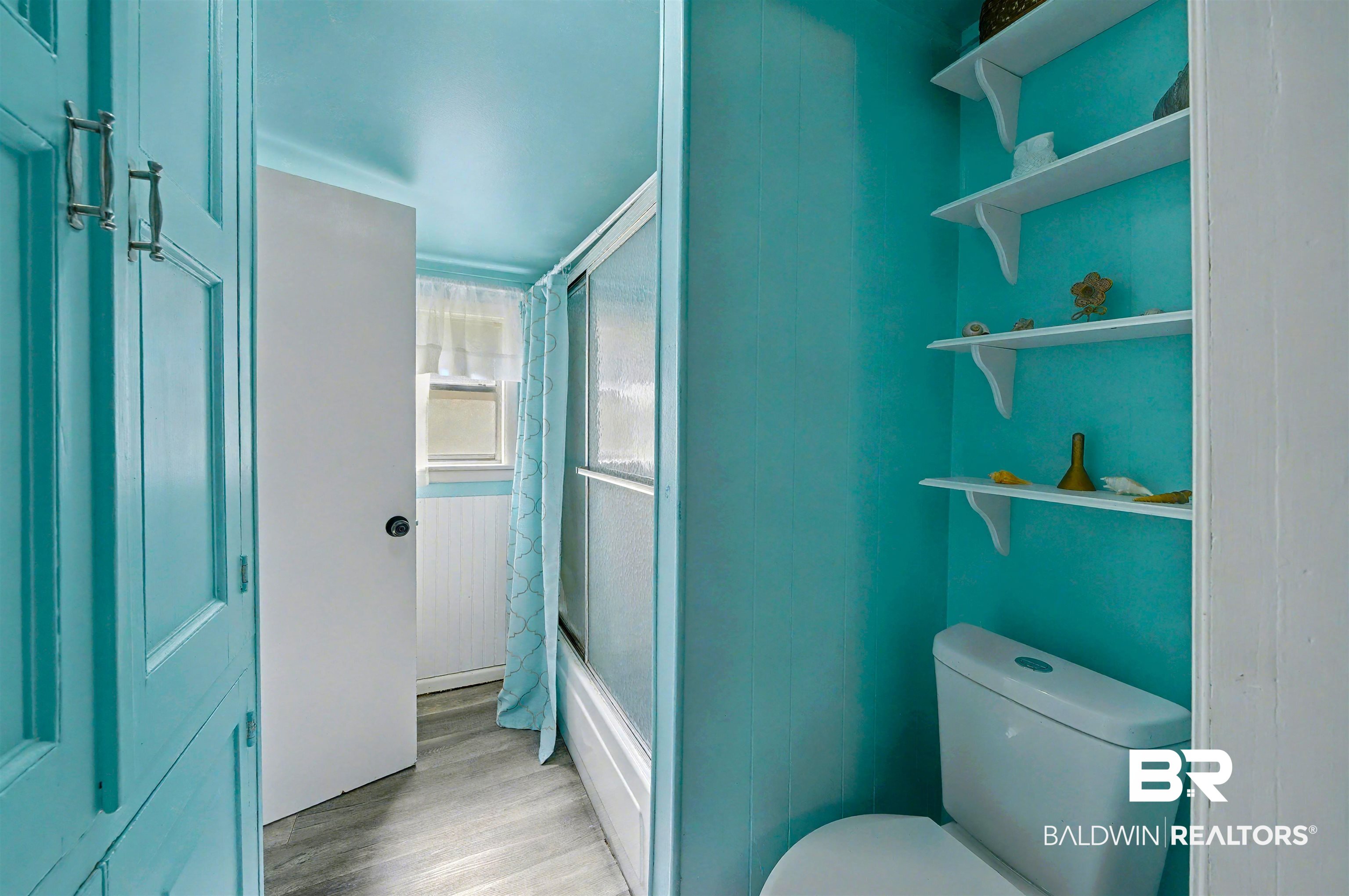 209 West Magnolia Avenue Foley, AL 36535 - Photo 17 of 23 Bathroom with light wood-style floors and toilet
