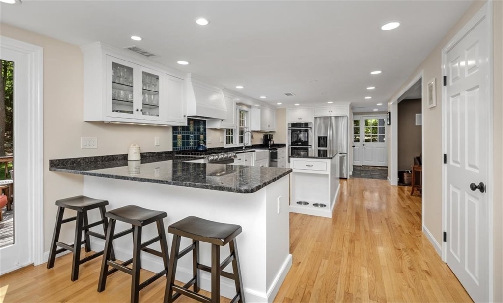 198 Pine Street Norwell, MA 02061 - Photo 2 of 31 a kitchen with stainless steel appliances granite countertop sink microwave and wooden floor