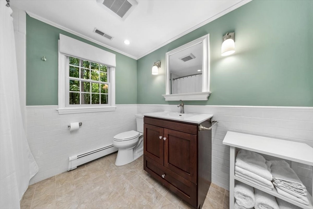 198 Pine Street Norwell, MA 02061 - Photo 23 of 31 a bathroom with a double vanity sink a toilet and a tub