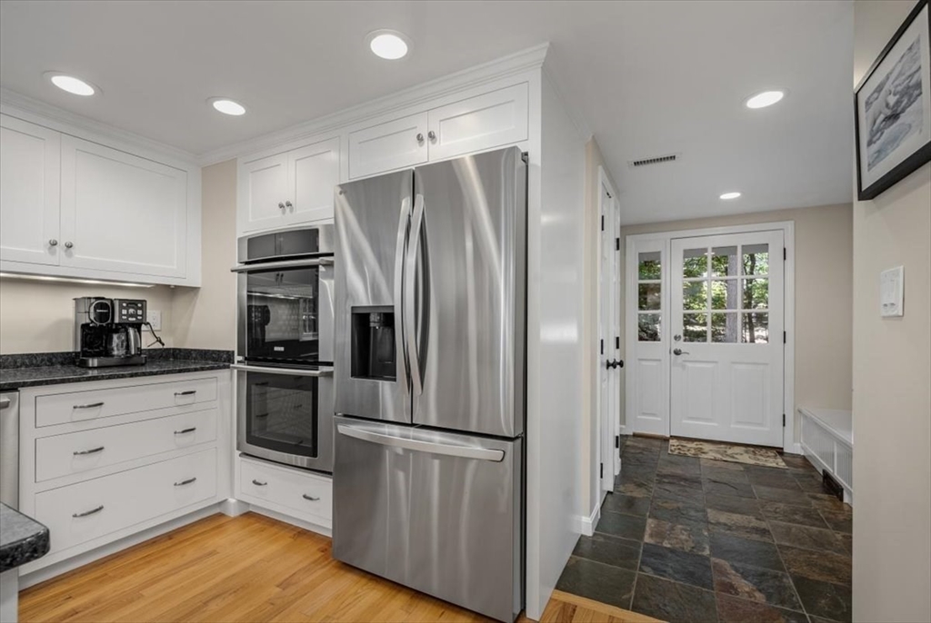 198 Pine Street Norwell, MA 02061 - Photo 6 of 31 a kitchen with granite countertop a refrigerator and a stove top oven