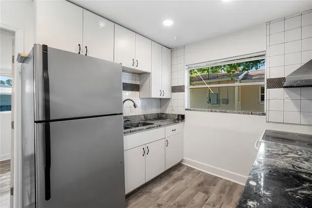 a white refrigerator freezer sitting inside of a kitchen