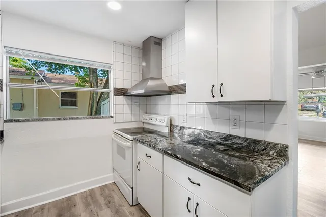 a kitchen with stainless steel appliances granite countertop a sink and a stove