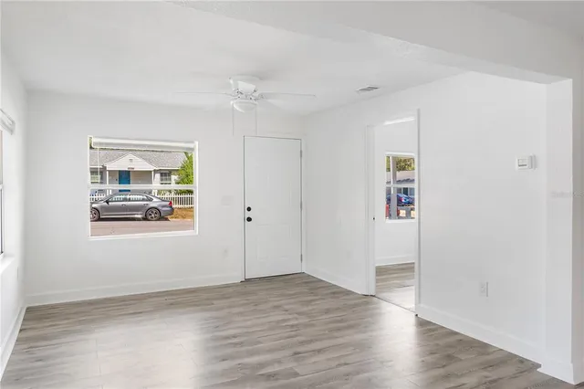 wooden floor in an empty room with a window