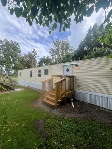 a view of a backyard with a small deck and a garden