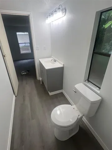 a white toilet sitting next to a bathroom sink