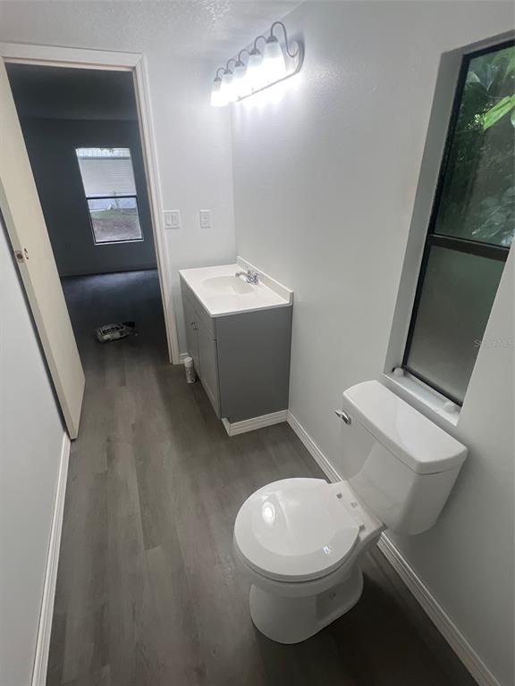 1001 Northeast 77th Street, Unit 3 Ocala, FL 34479 - Photo 11 of 20 a white toilet sitting next to a bathroom sink