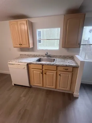 a kitchen with a sink stove and cabinets