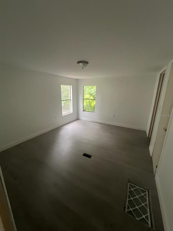 1001 Northeast 77th Street, Unit 3 Ocala, FL 34479 - Photo 8 of 20 an empty room with windows